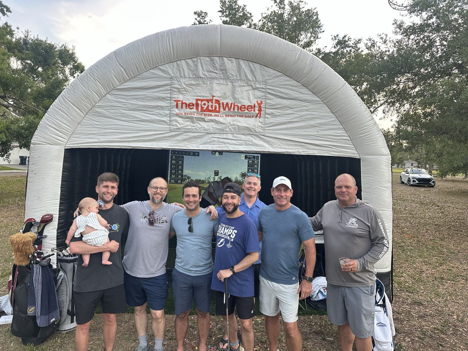 Group of golfers in front of The 19th Wheel inflatable simulator dome